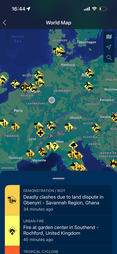 Global Monitoring app screen displaying a world map with security alert icons and a list of real-time incident notifications