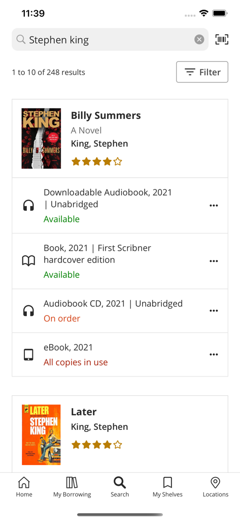 Search results interface of the Surrey Libraries app displaying titles by Stephen King with availability status for various formats.