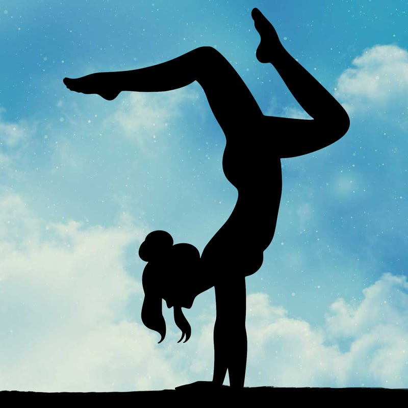 a woman doing a handstand
