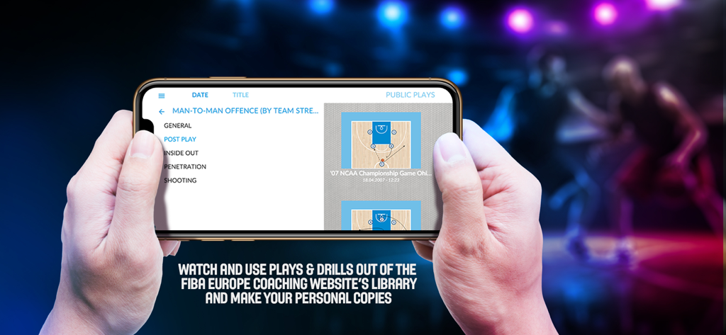 A person holding a smartphone displaying basketball offensive plays and tactical diagrams from the FIBA coaching app