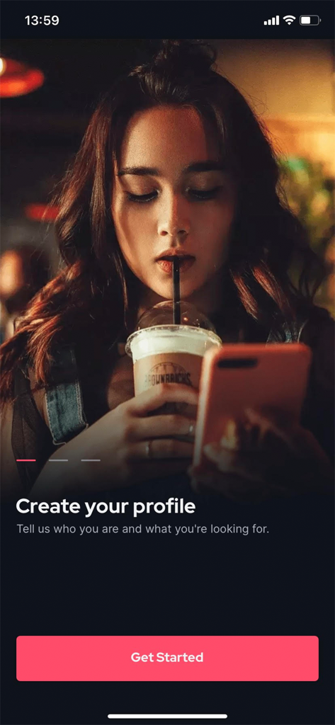 A young woman holding a smartphone and a drink on the BeeDee app onboarding screen with a prompt to create a profile