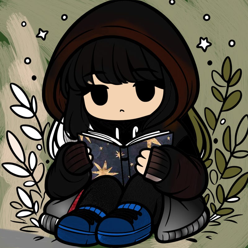 girl in oversized hoodie reading a book