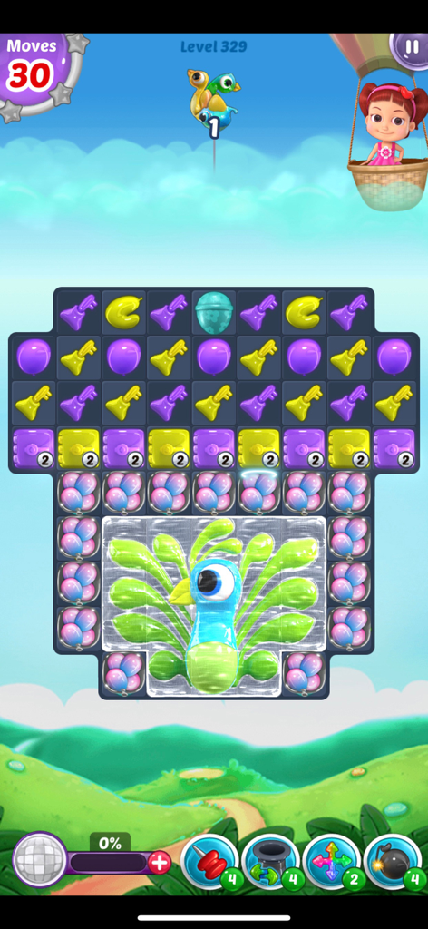 Balloon Paradise match-3 puzzle level with colorful balloons and a frozen peacock.
