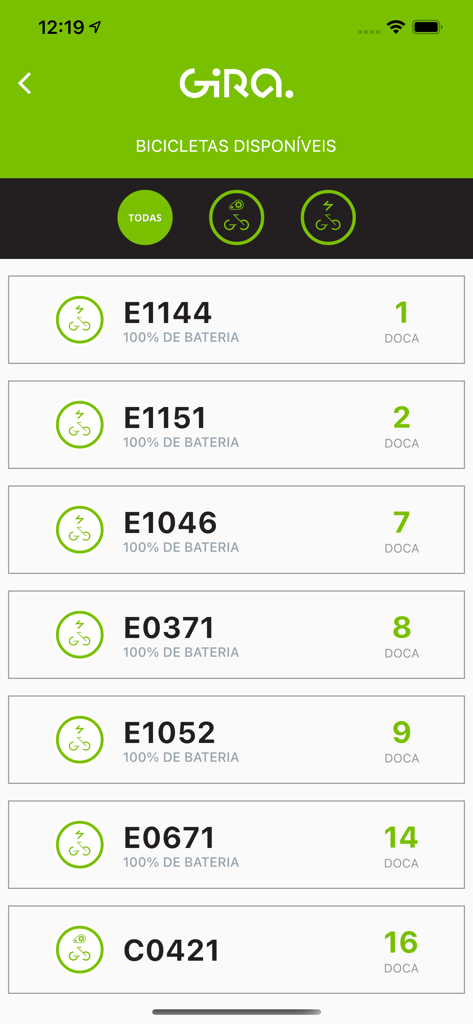 A list of available rental bikes in the Gira Lisbon app showing battery levels and dock numbers.