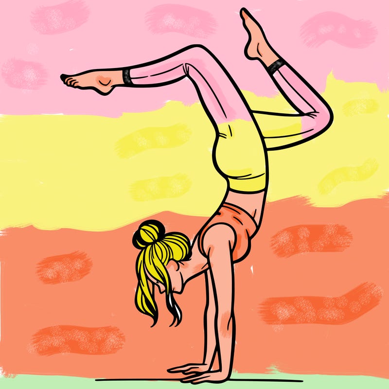 a woman doing a handstand