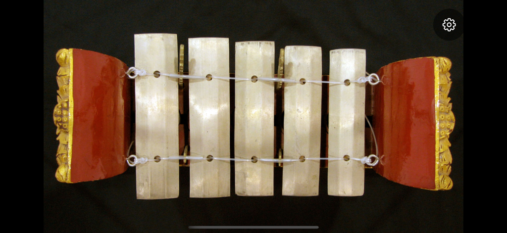 Gangsa - Top down view of a digital Balinese Gangsa instrument with metal bars and ornate red housing