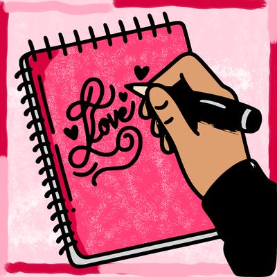 a hand writing “love” in calligraphy on a notebook