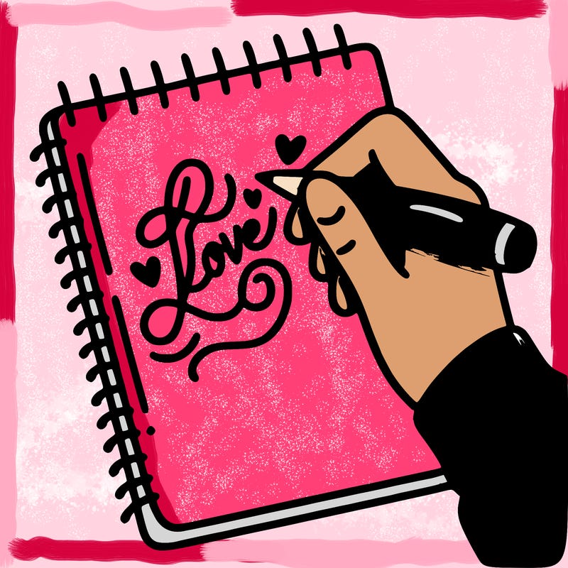 a hand writing “love” in calligraphy on a notebook