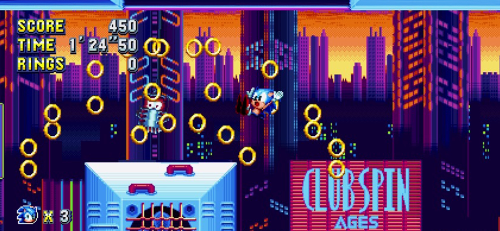 Sonic Mania Plus - NETFLIX - Sonic the Hedgehog salta attraverso anelli dorati in un livello urbano retrò pixel art