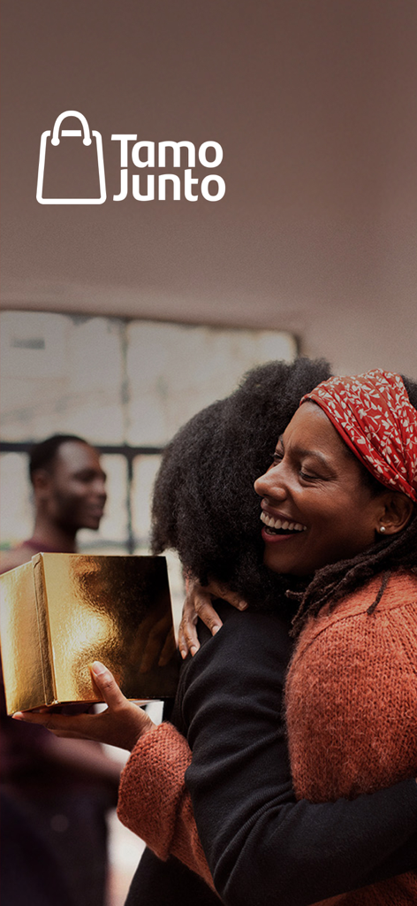 Banco Santander Brasil - Una mujer sonriente abrazando a una amiga mientras sostiene una caja de regalo dorada bajo el logo Tamo Junto de Santander