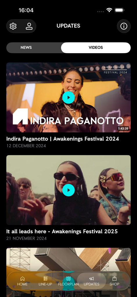 Pantalla de actualizaciones de la aplicación móvil Awakenings Festival que muestra un feed de videos y noticias del festival