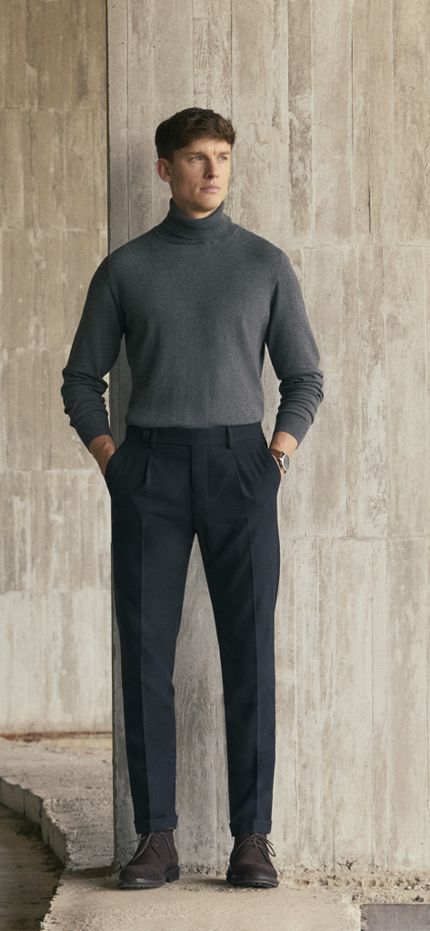 Alvaro Moreno - Male model wearing a grey turtleneck and dark trousers
