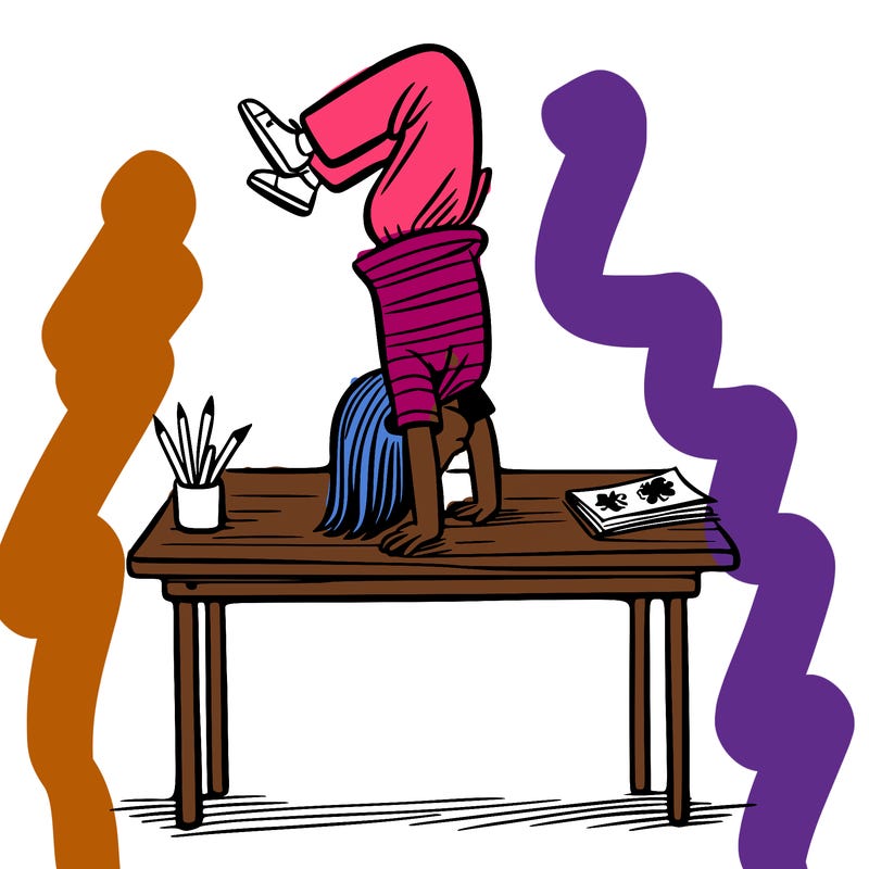 girl doing handstand on desk