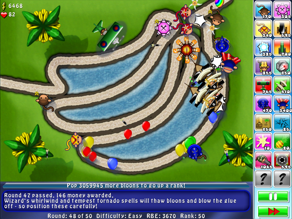 Bloons TD 4 HD gameplay showing tower defense strategy on a banana shaped track