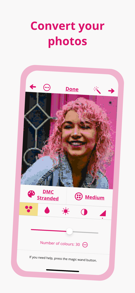 A screenshot of the Stitchly app interface showing a photo of a woman with pink hair being converted into a cross-stitch pattern with DMC thread options.