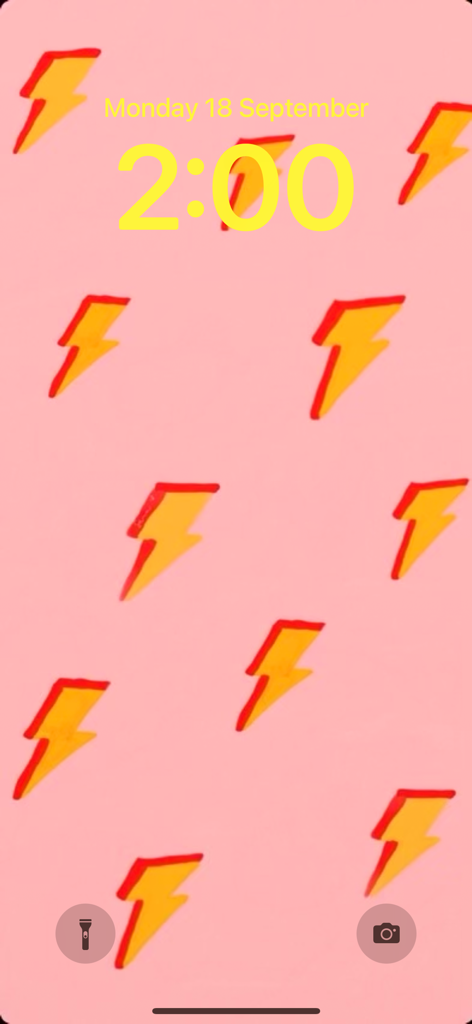 iPhone lock screen with a pink background and yellow lightning bolt patterns
