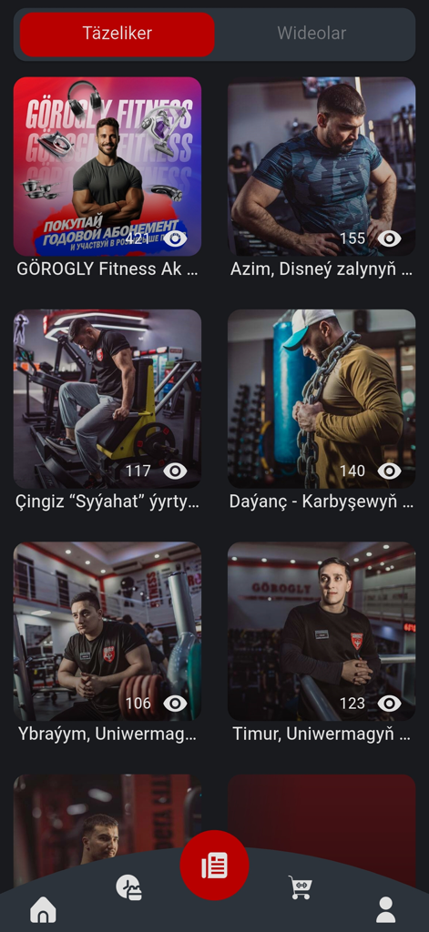 Tela de aplicativo móvel mostrando uma grade de perfis de instrutores de fitness e vídeos de treinos de academia