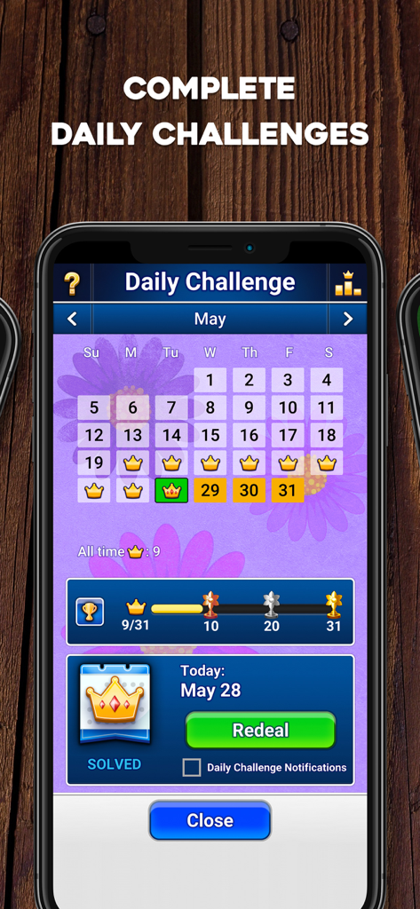 TriPeaks Solitaire: Card Game - TriPeaks Solitaire app screen showing a calendar with crowns for completed daily challenges