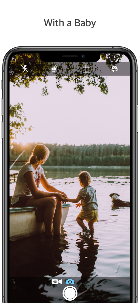 A woman and a child sitting by a lake at sunset, illustrating the silent camera feature of the Q Camera app.