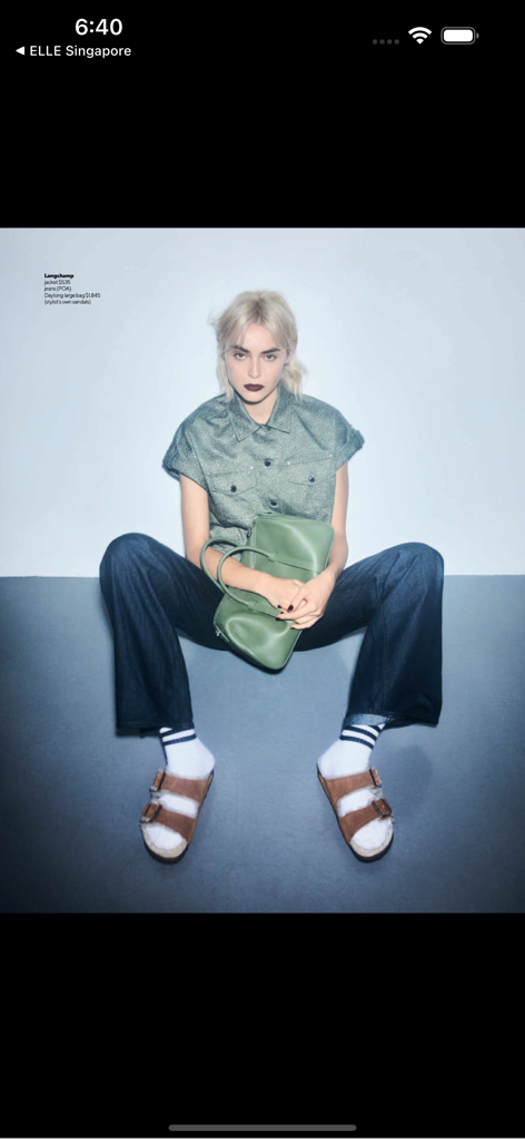 A fashion model in Nuyou Singapore magazine wearing a green jacket and holding a matching Longchamp handbag