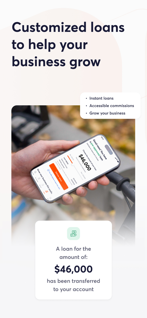 A person holding a phone showing a business loan offer and a confirmation of funds transferred in the Clip app.
