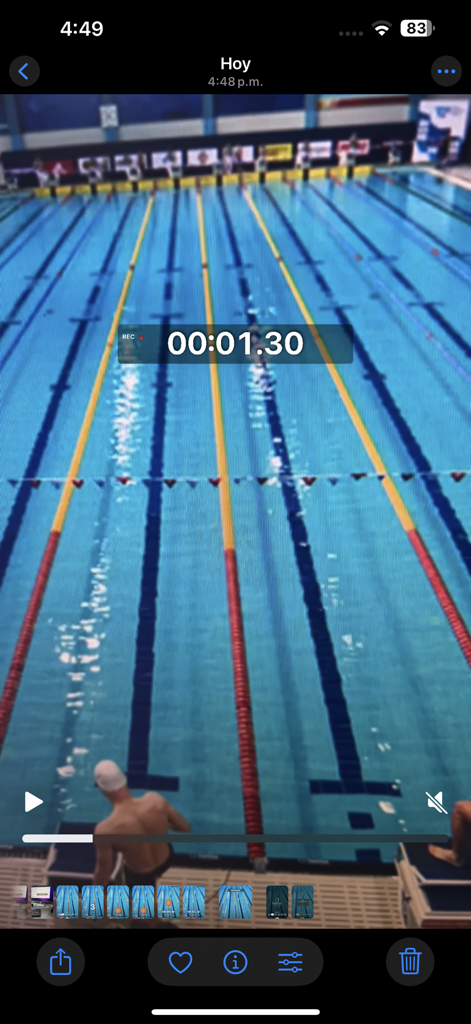 SwimCam - SwimCam app screenshot showing a swimming pool video with a professional stopwatch overlay