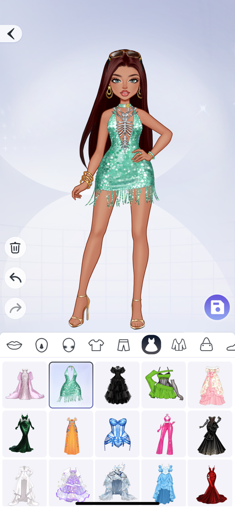 YoYa Sparkle: Style Pop - Una pantalla de personalización de avatar de moda en YoYa Sparkle Style Pop con un personaje con un vestido verde brillante de flecos y un menú de varias opciones de atuendo