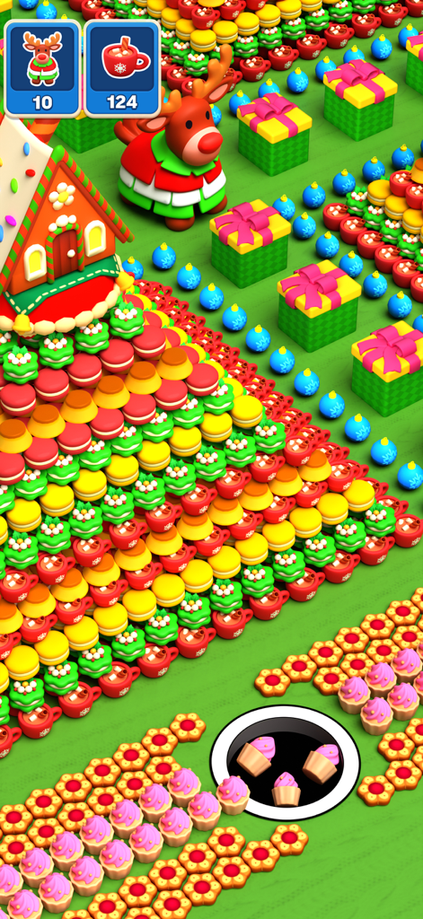 A black hole swallowing cupcakes in a festive Christmas themed level of the Holy Hole mobile game