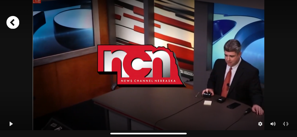 A live news broadcast on the News Channel Nebraska app featuring an anchor in a studio with the NCN logo displayed