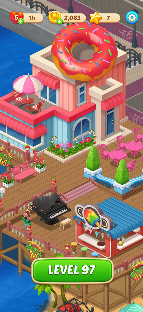 Happy Match Cafe™ - Escena del nivel de juego de Happy Match Cafe mostrando un café rosa decorado con una dona gigante en el techo y un muelle junto al mar