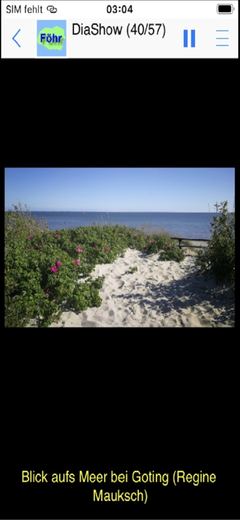 Schermata di slideshow nell'app vacanze Föhr che mostra una vista panoramica del mare e della sabbia sulla spiaggia di Goting