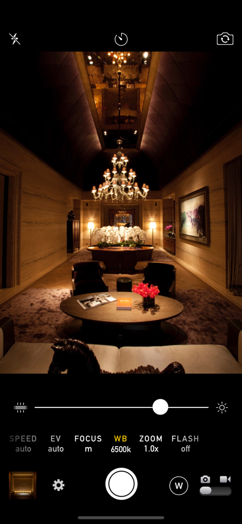 Manual Camera 4 - Manual Camera 4 app interface showing manual controls for exposure, focus, and white balance while capturing a low-light indoor scene.