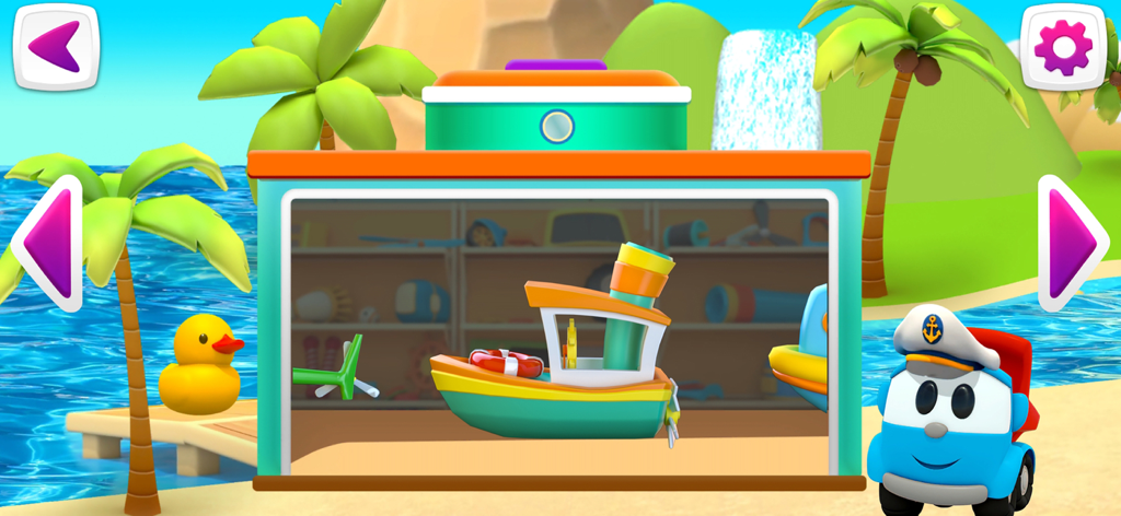 トロピカルビーチの風景の中にいるレオ・ザ・トラックと、コンストラクターガレージの中のおもちゃのボート。