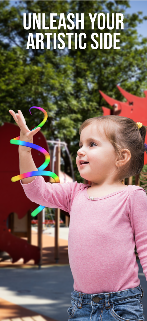 Magic Art - Augmented Reality - Young girl using augmented reality to create colorful 3D art outdoors