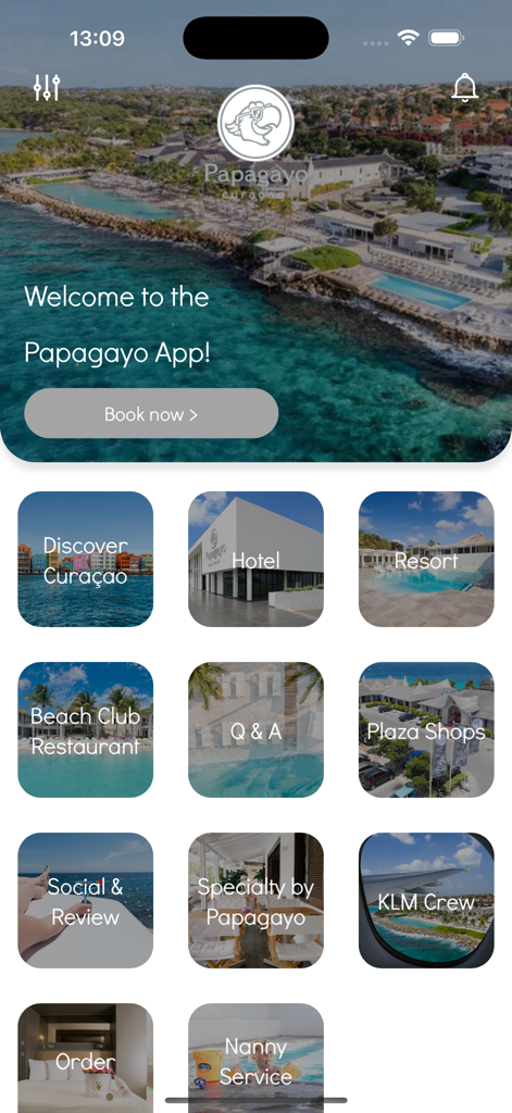 La schermata principale dell'app di viaggio Papagayo che mostra i servizi di lusso del resort e un pulsante Prenota ora