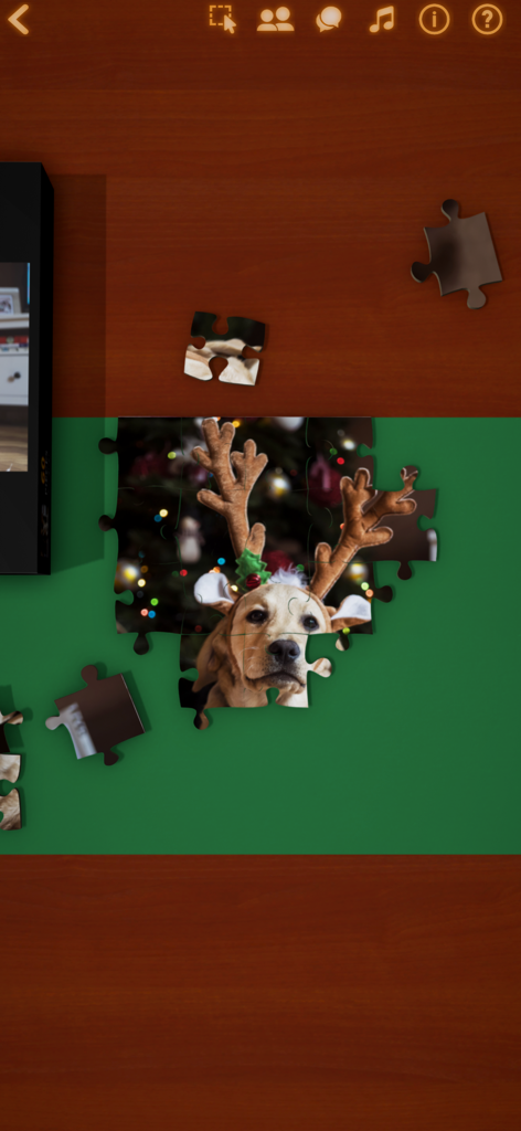 A digital jigsaw puzzle of a dog with reindeer antlers being assembled in the app