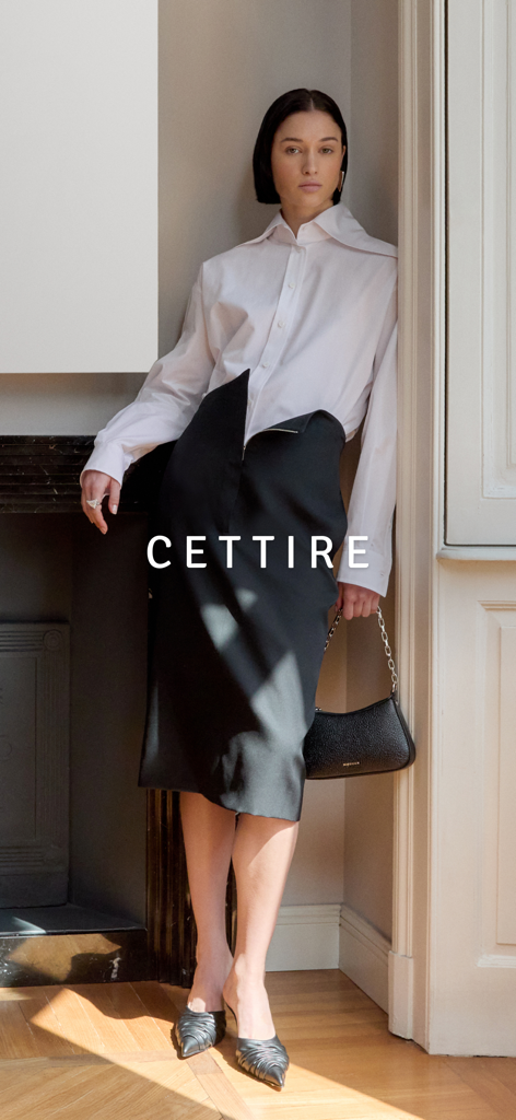 CETTIRE - A woman modeling high-end designer clothing and a handbag from the Cettire luxury fashion app