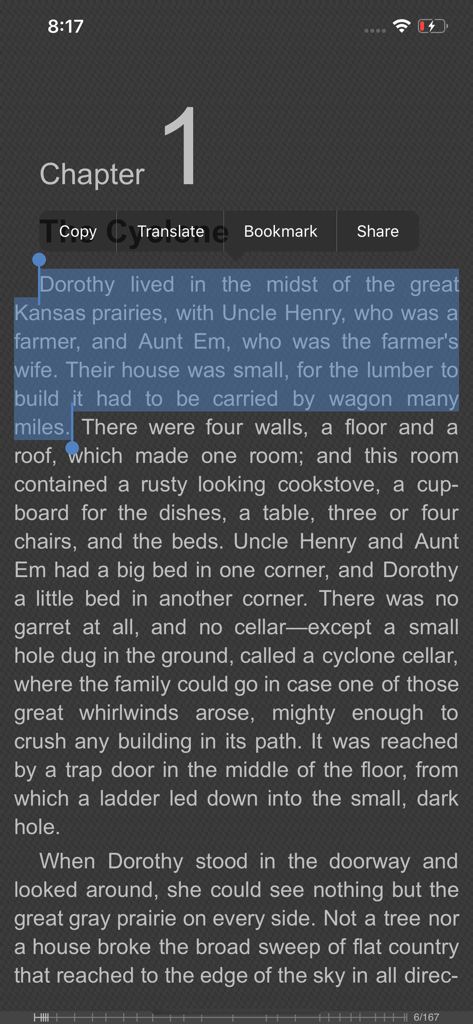 Interface do aplicativo FBReader em um iPhone exibindo um capítulo de livro com texto selecionado e um menu para copiar, traduzir e marcar