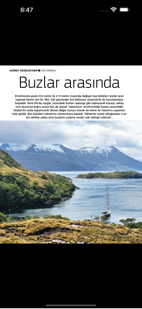 Naviga Magazine - A sailboat in a scenic bay with snow-capped mountains featured in a Naviga Magazine article.