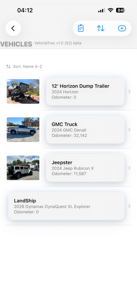 VehicleTrax - Mobile app screen showing a list of tracked vehicles including a trailer, GMC truck, Jeep, and motorhome with odometer data.
