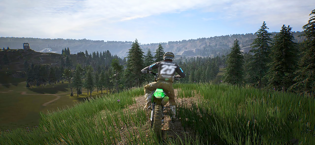 Freestyle Motocross Skill 3D - Um piloto de motocross em uma moto de sujeira verde olhando para uma paisagem cênica de floresta e montanha no jogo Freestyle Motocross Skill 3D.