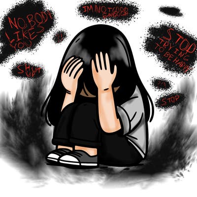 girl sitting down covering her head