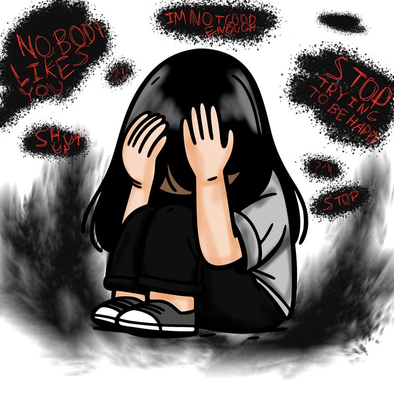 girl sitting down covering her head