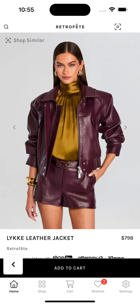 Retrofête app showcasing a model wearing the Lykke Leather Jacket in burgundy with a gold silk top