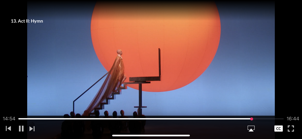 Met Opera on Demand - Met Opera on Demand video player interface showing a stage performance of Act II Hymn