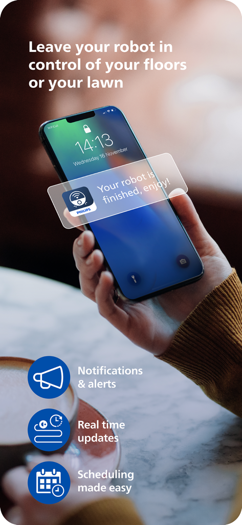 Philips HomeRun Robot App - A person holding a smartphone displaying a Philips HomeRun app notification saying your robot is finished enjoy.