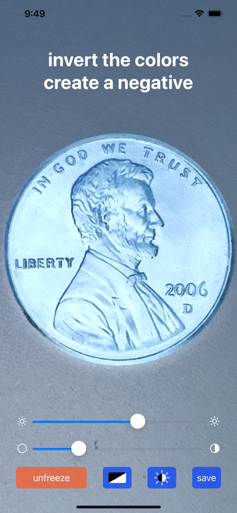 Magnifying Glass & Mirror - Magnifying glass app showing a zoomed in penny with inverted colors in negative mode for high contrast visibility.