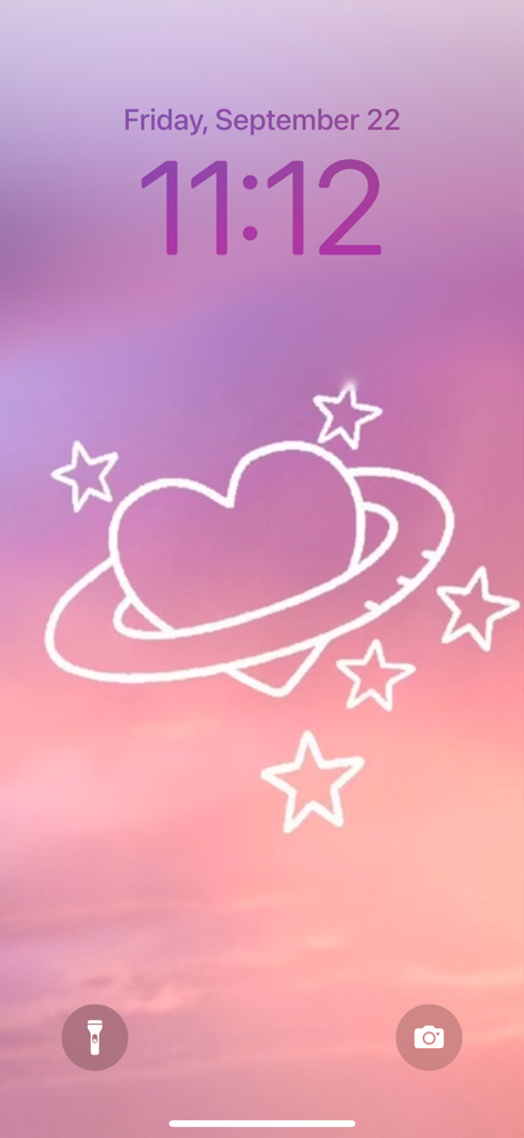 iPhone lock screen with a pink and purple sunset background and a heart planet illustration.