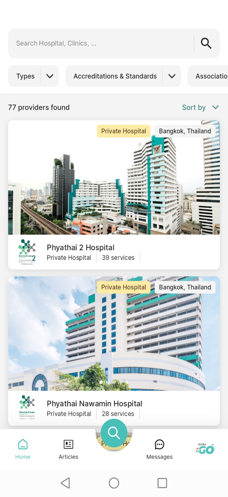 ArokaGO - The ArokaGO app interface showing a list of accredited private hospitals in Bangkok Thailand with medical services count.
