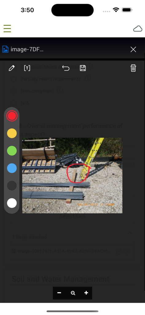 A screenshot of the InEight mobile app showing a construction site photo being annotated with a red circle for safety reporting.